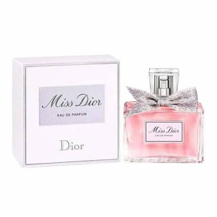 Dior Miss Dior Eau de Parfum bottle with a pink liquid and silver bow next to its white packaging box.