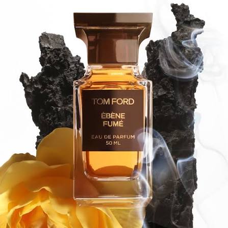 Tom Ford Ebene Fume perfume bottle with a yellow rose and dark rock background