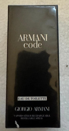 Giorgio Armani Code Eau de Toilette refillable spray box in black with gold lettering, photographed on a light textured surface.