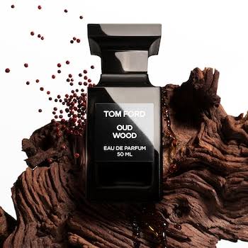Tom Ford Oud Wood perfume bottle on a textured brown background