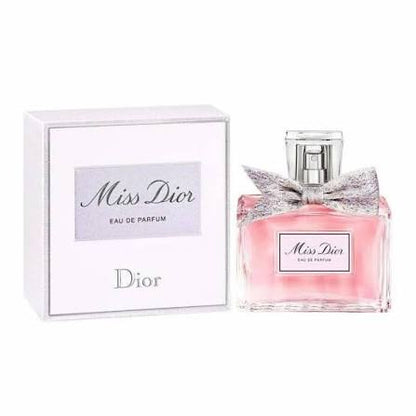 Dior Miss Dior Eau de Parfum bottle with a pink liquid and silver bow next to its white packaging box.