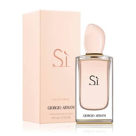 Giorgio Armani Si Eau de Toilette bottle with a pale pink cap and clear glass, standing next to its light pink packaging box on a white background.
