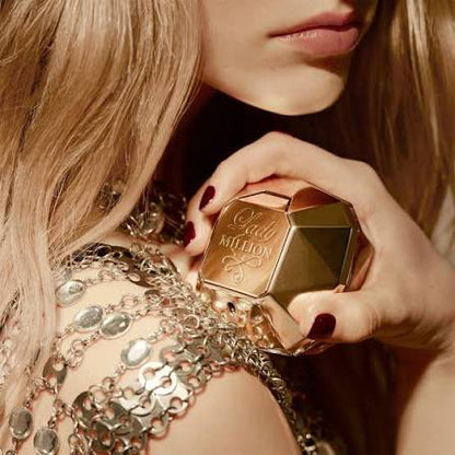 Gold perfume bottle with 'Ladur Million' with girl