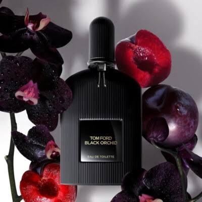 Tom Ford Black Orchid perfume bottle surrounded by flowers on a gray background
