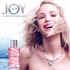 Woman with a necklace and a product labeled 'Joy' in the background
