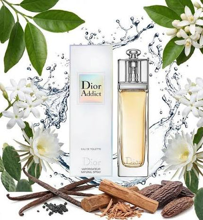Dior Addict Eau de Toilette bottle and box shown with white flowers, green leaves, vanilla beans, and cinnamon sticks on a white background with water splash graphics.