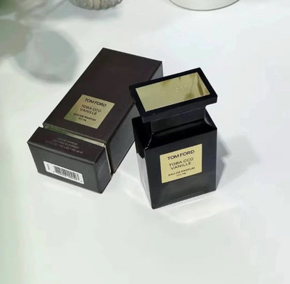 Tom Ford perfume bottle and box on a white surface