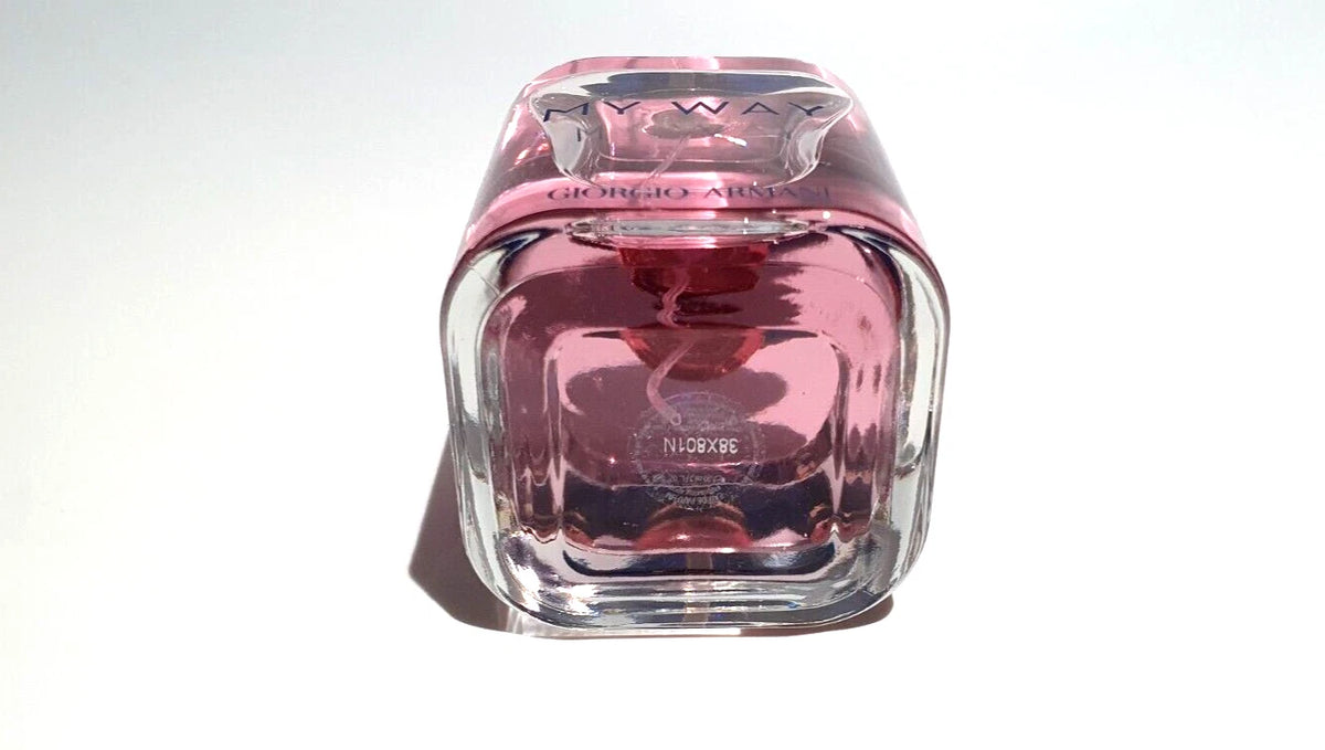 A Giorgio Armani Nympha perfume bottle with a distinctive square, faceted clear glass body filled with pink liquid, topped with a matching pink cap, set against a plain white background.